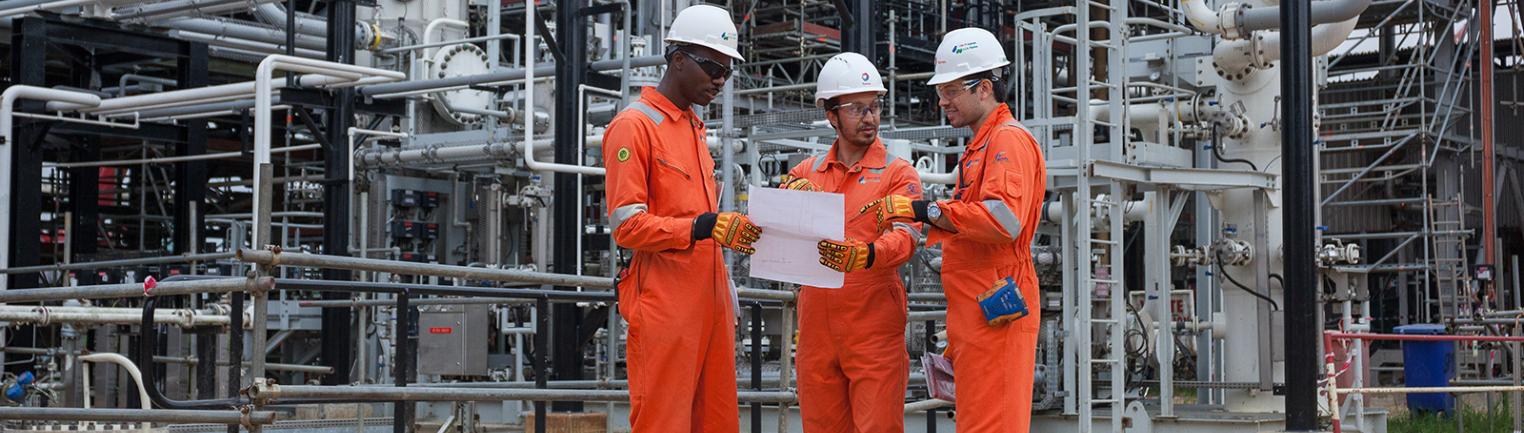 Operators carry out an inspection at a pumping station in Ogbogu, Nigeria.